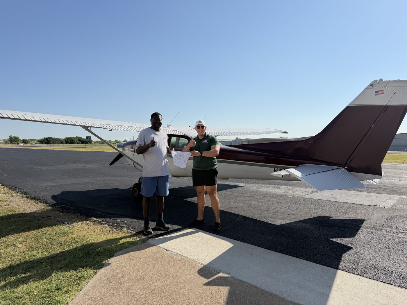 Adam Fields and a student giving thumbs up after the student's first solo